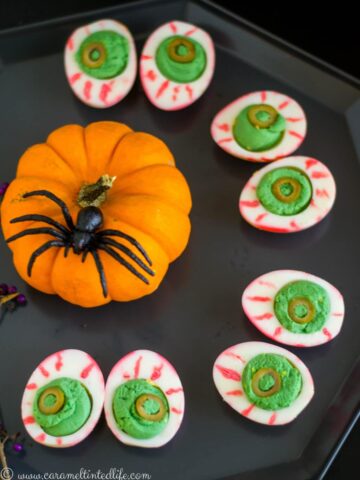 Halloween Deviled Eggs with a pumpkin and spider