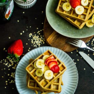 Waffles with bananas, strawberries on a plate