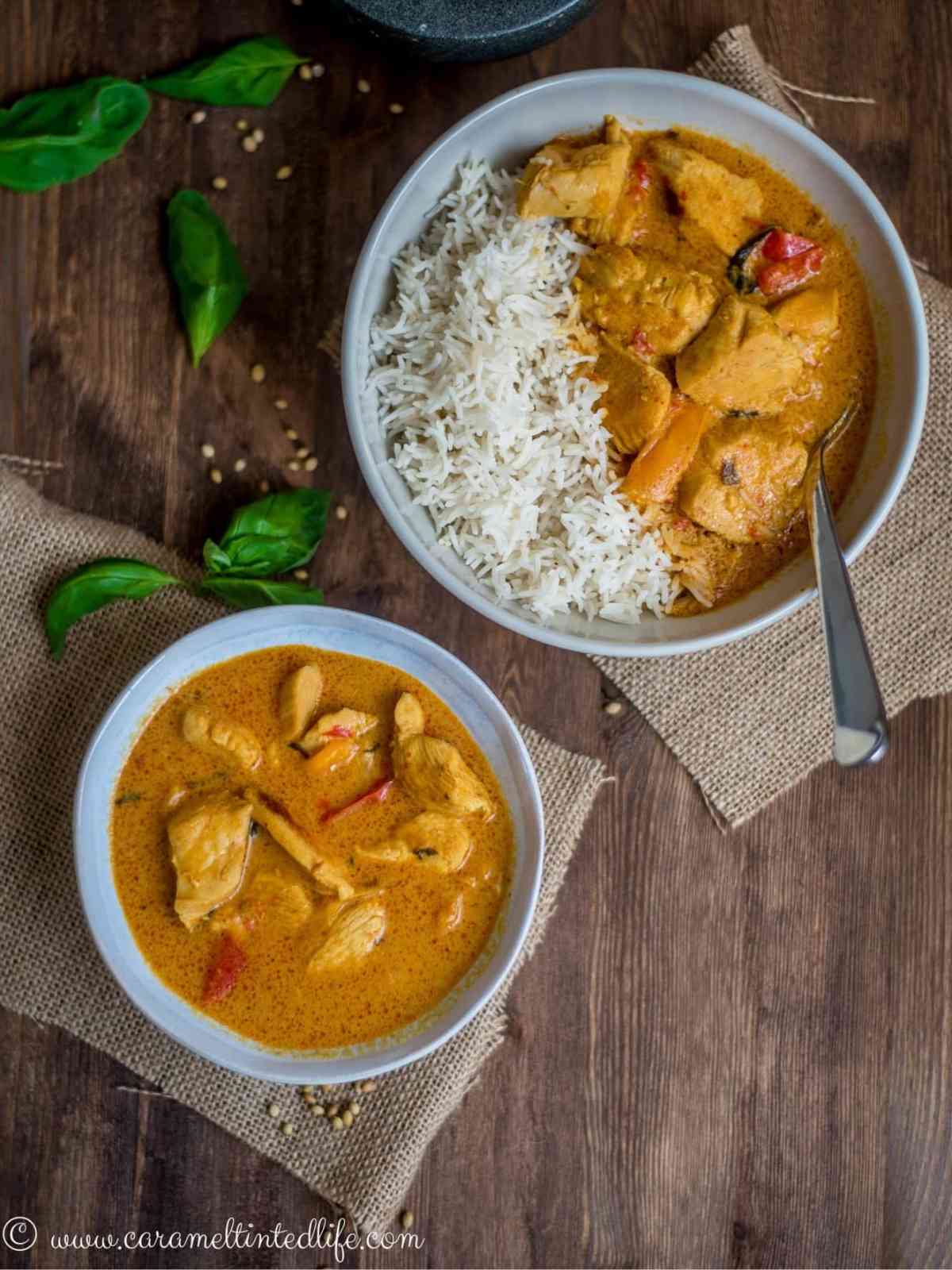 Two bowls of thai chicken curry and rice