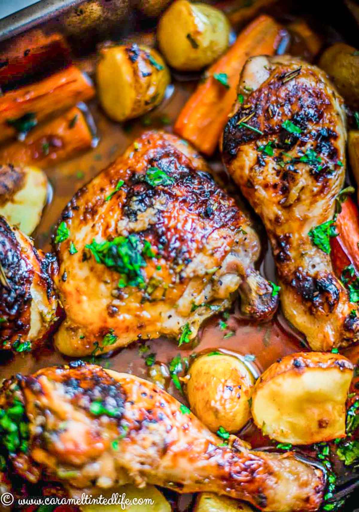 close-up of roasted chicken legs and thighs in honey garlic sauce 