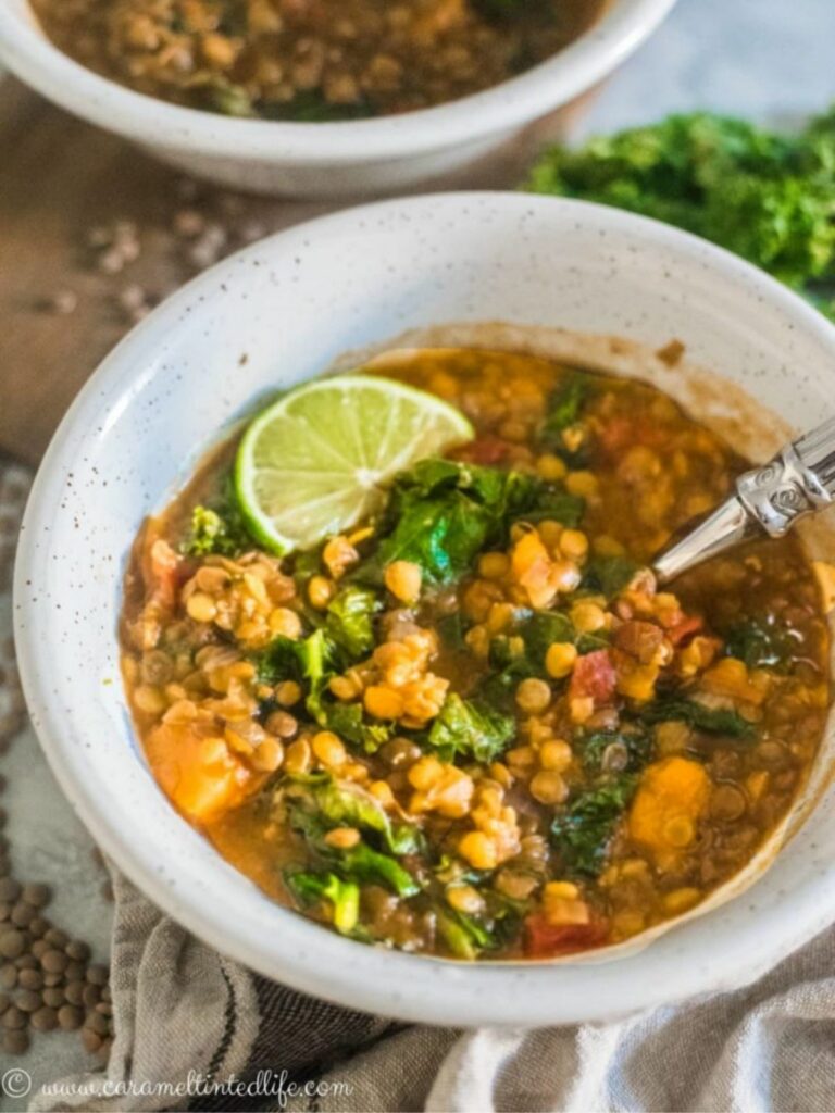 Instant Pot Lentil Soup with Kale and Sweet Potato in a bowl with a spoon