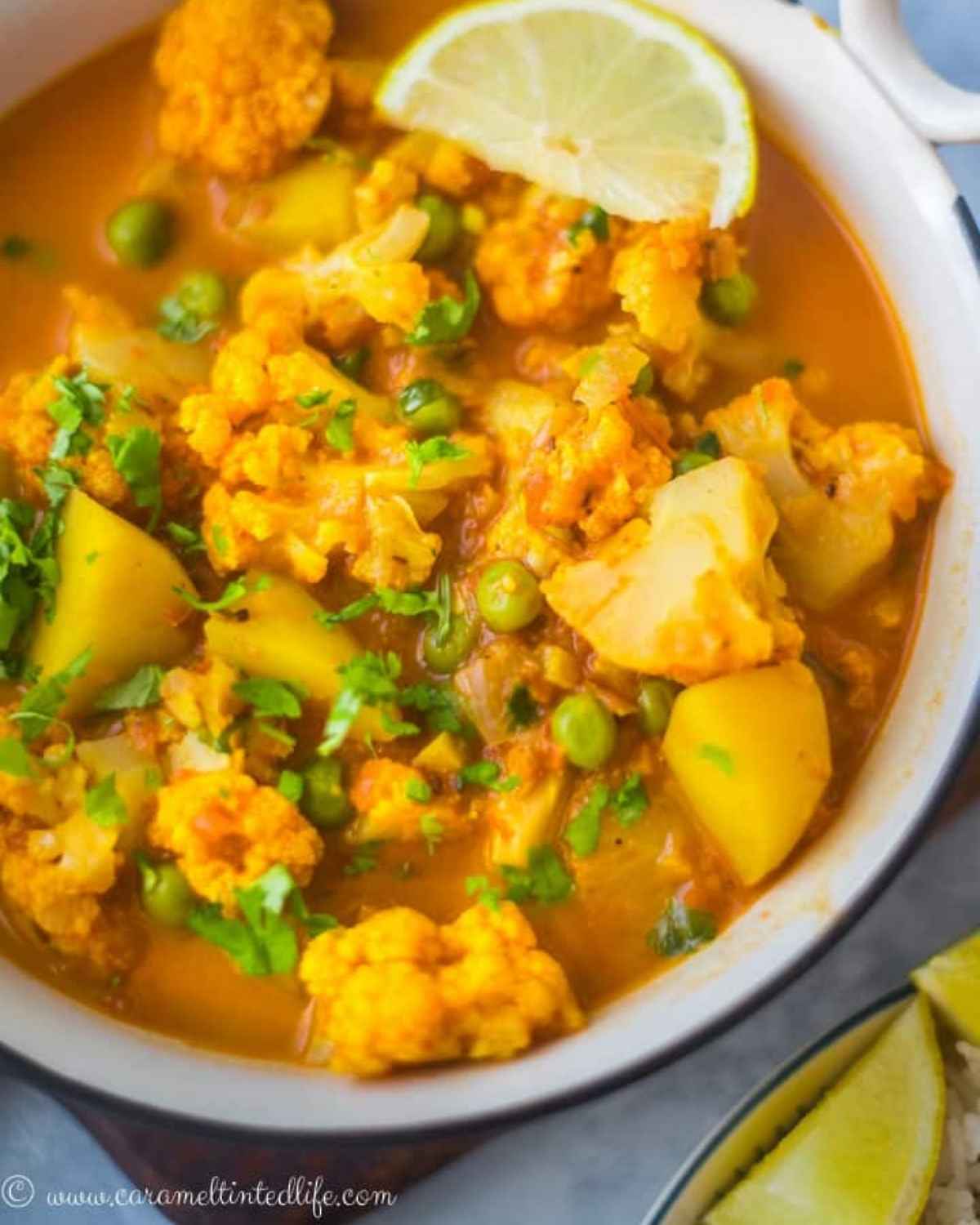 A bowl of cauliflower, potato and peas curry