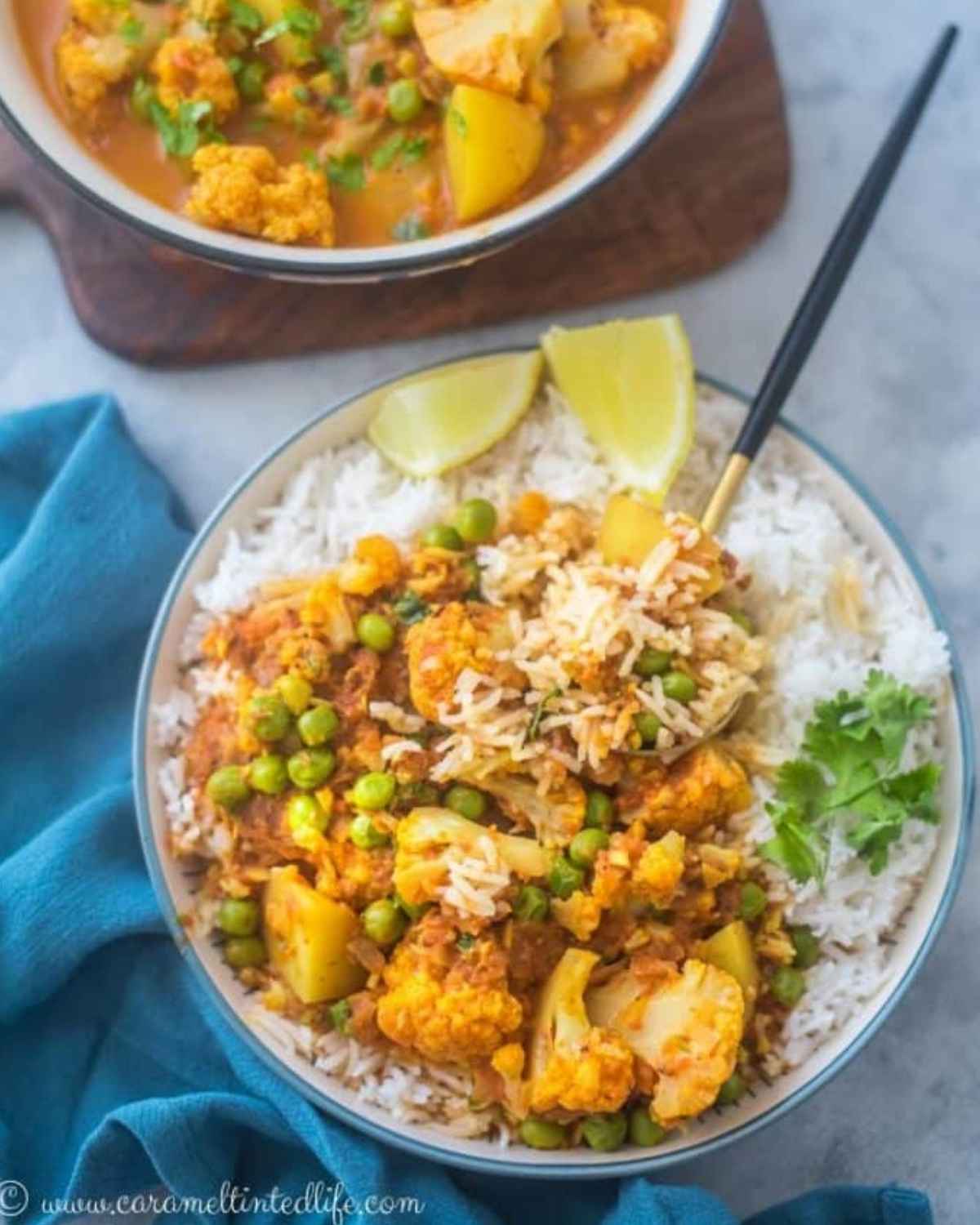 Top view of cauliflower and peas curry in a bowl with rice