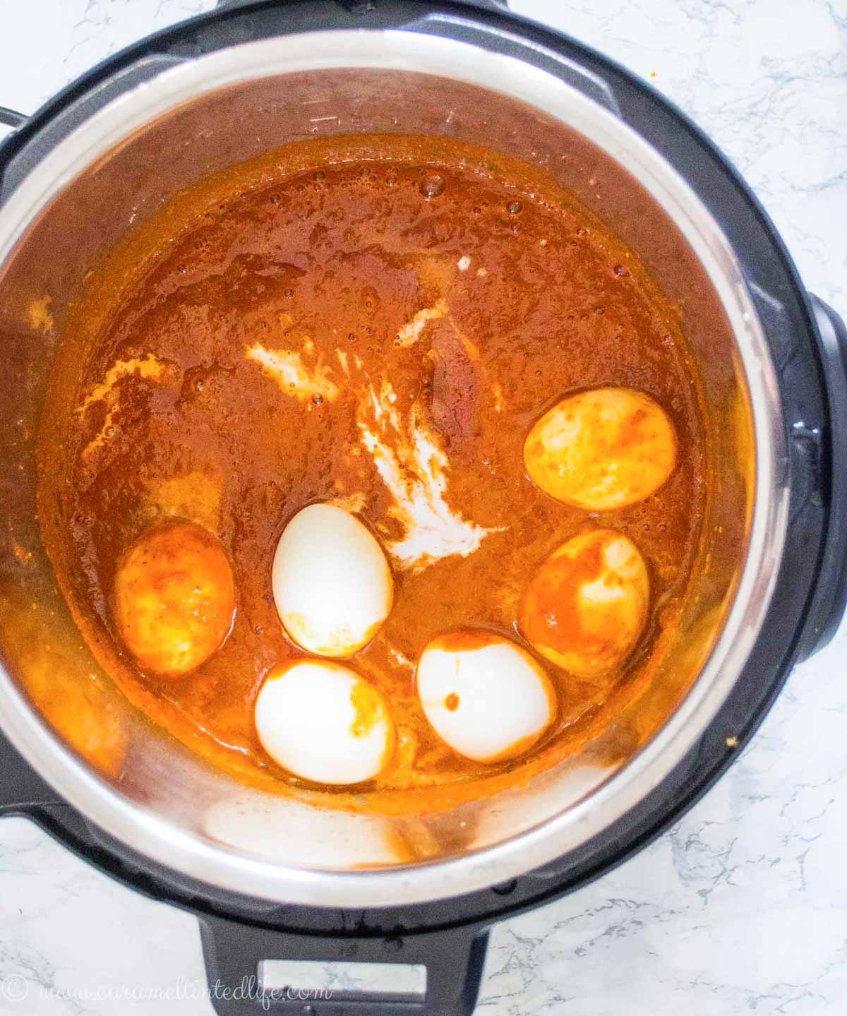 Egg curry getting ready in the Instant Pot, viewed from the top 