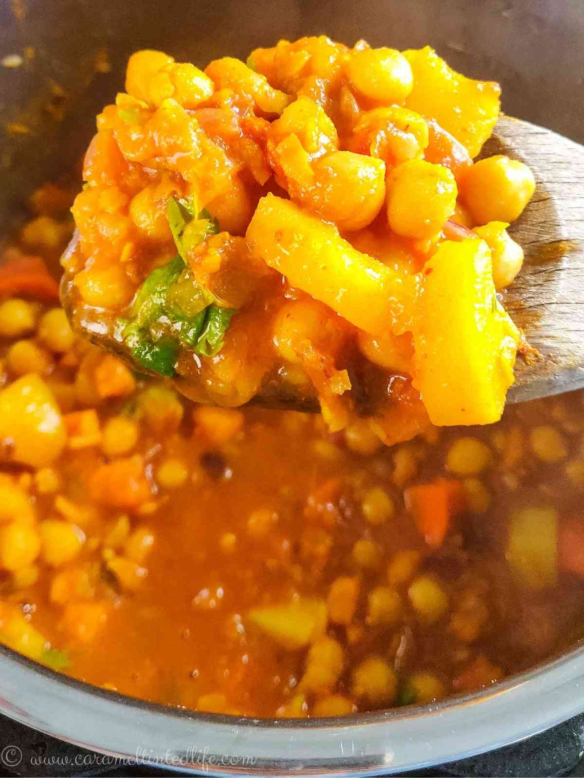 Chickpea tagine served with rice in a bowl with a spoon