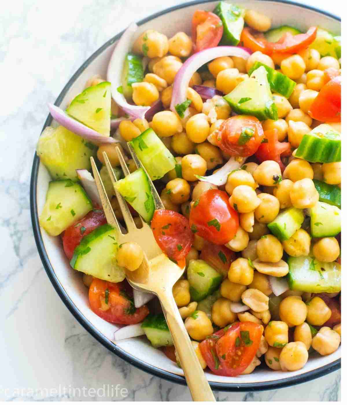 chickpea salad in a bowl with a fork