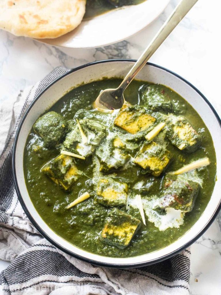 Saag paneer in a bowl with a fork