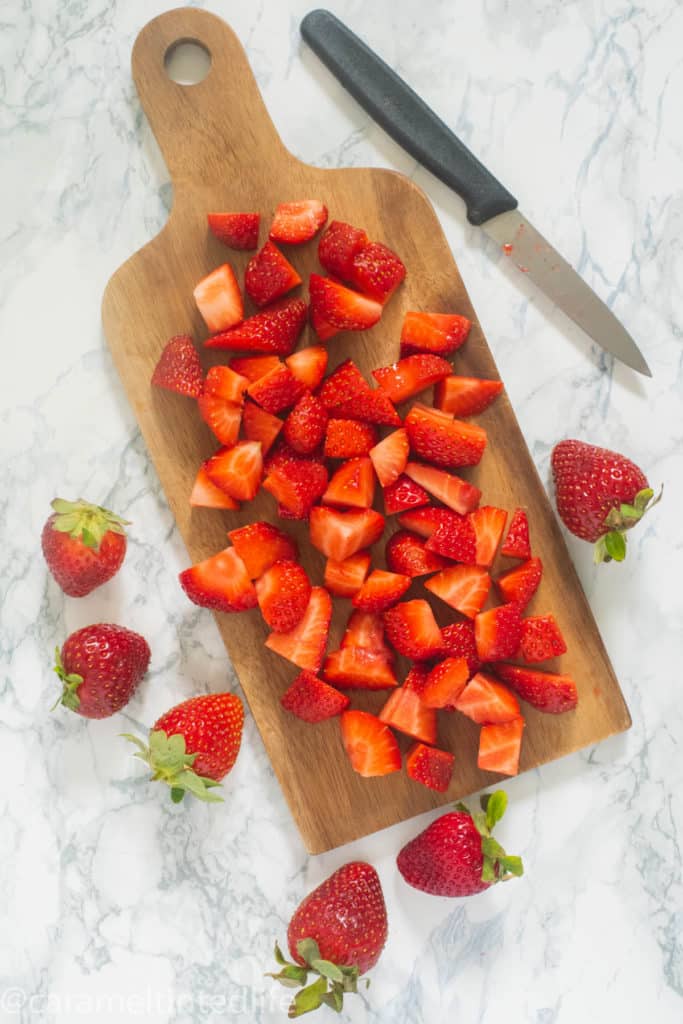 Chopped strawberries on a wooden board
