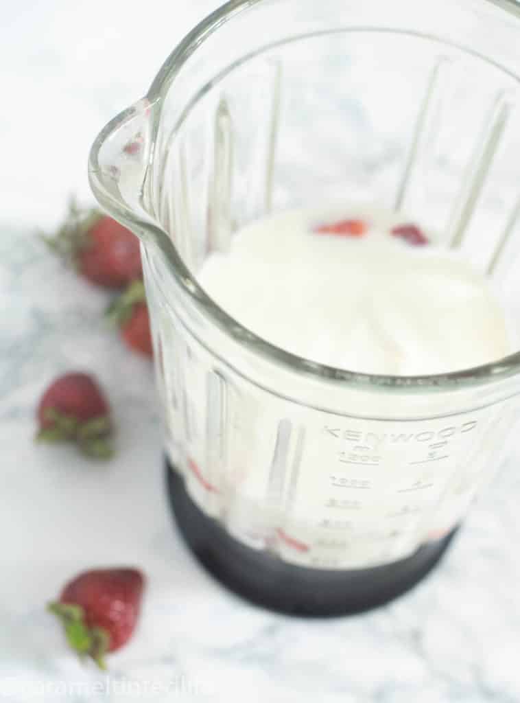 Yogurt and strawberries in a blender