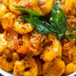 Close-up of shrimp masala, curry leaves, mustard seeds in a bowl