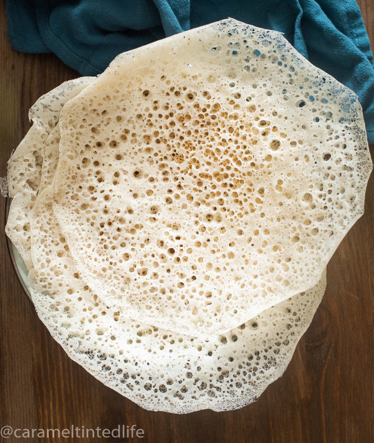 White Appams or hoppers on wooden board