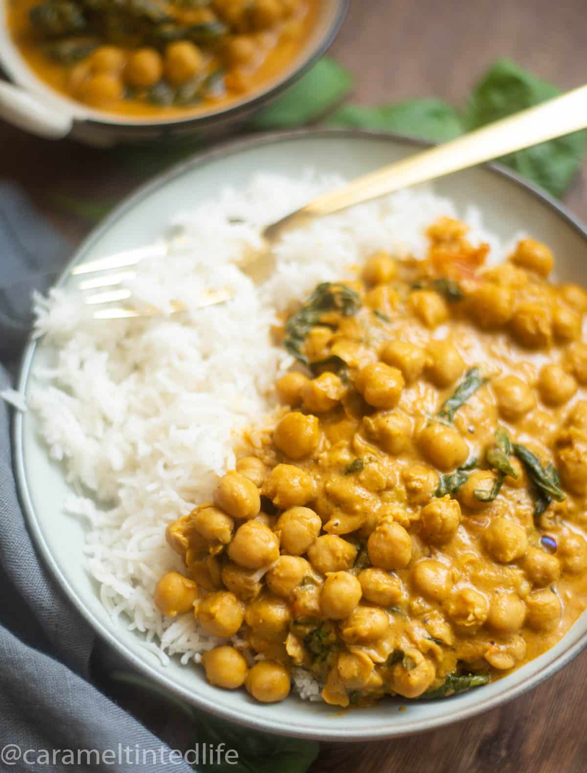 Close-up of chickpea coconut curry with spinach and rice