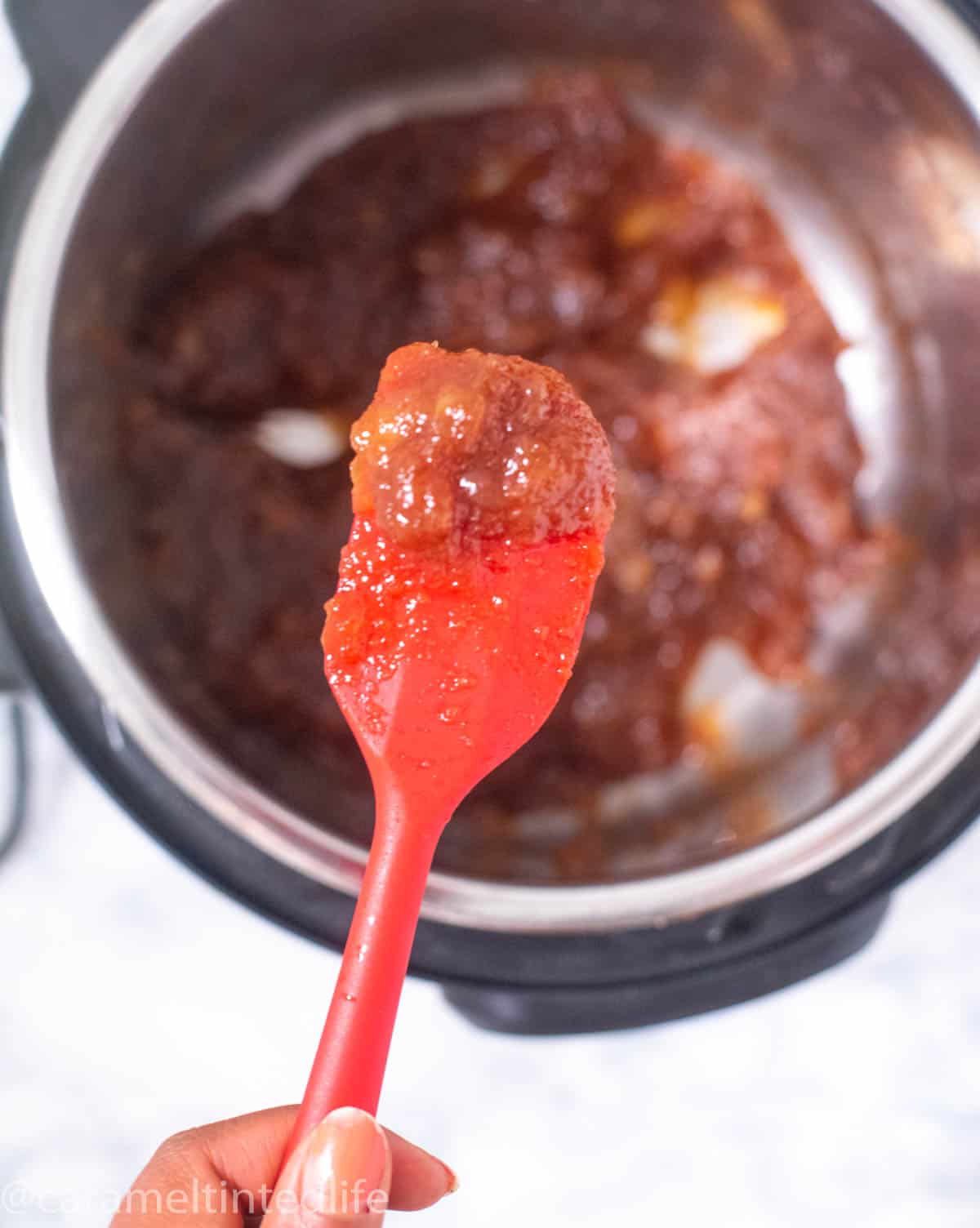 Apple jam on a red spatula