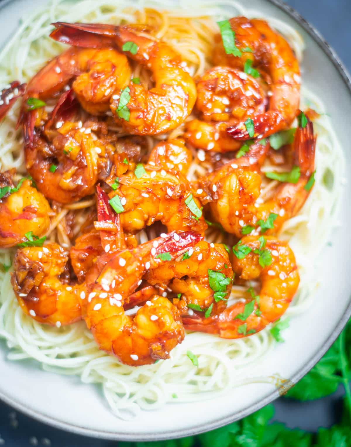 Prawns in honey garlic chili sauce on a bed of noodles
