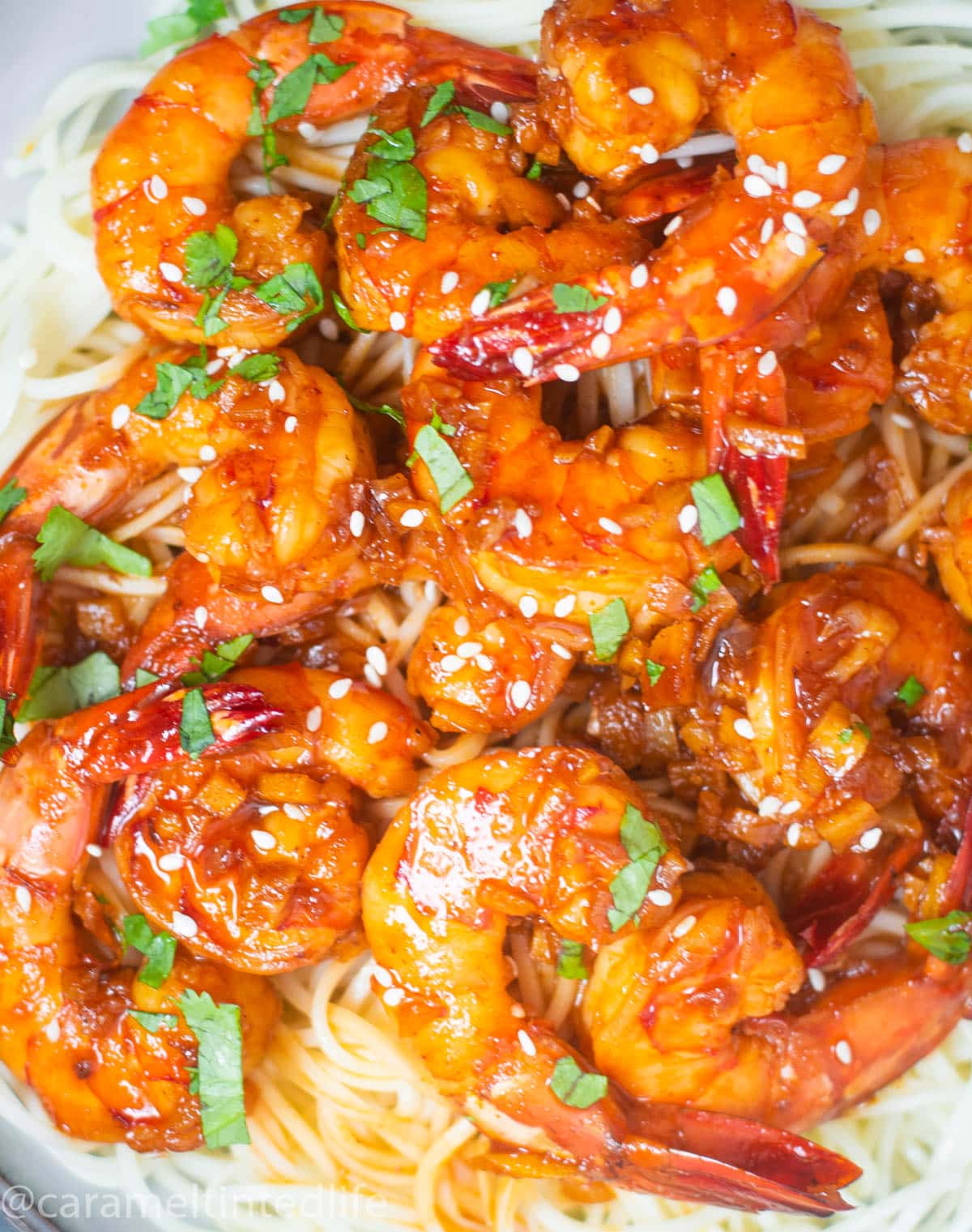 Prawns in honey garlic chili sauce on a bed of noodles