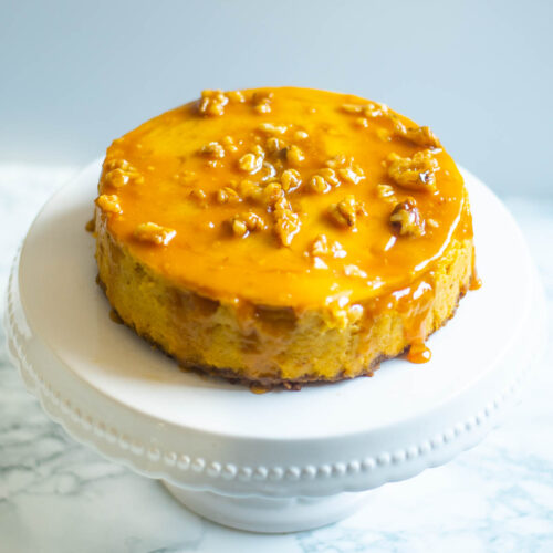 Pumpkin cheesecake on a white cake stand