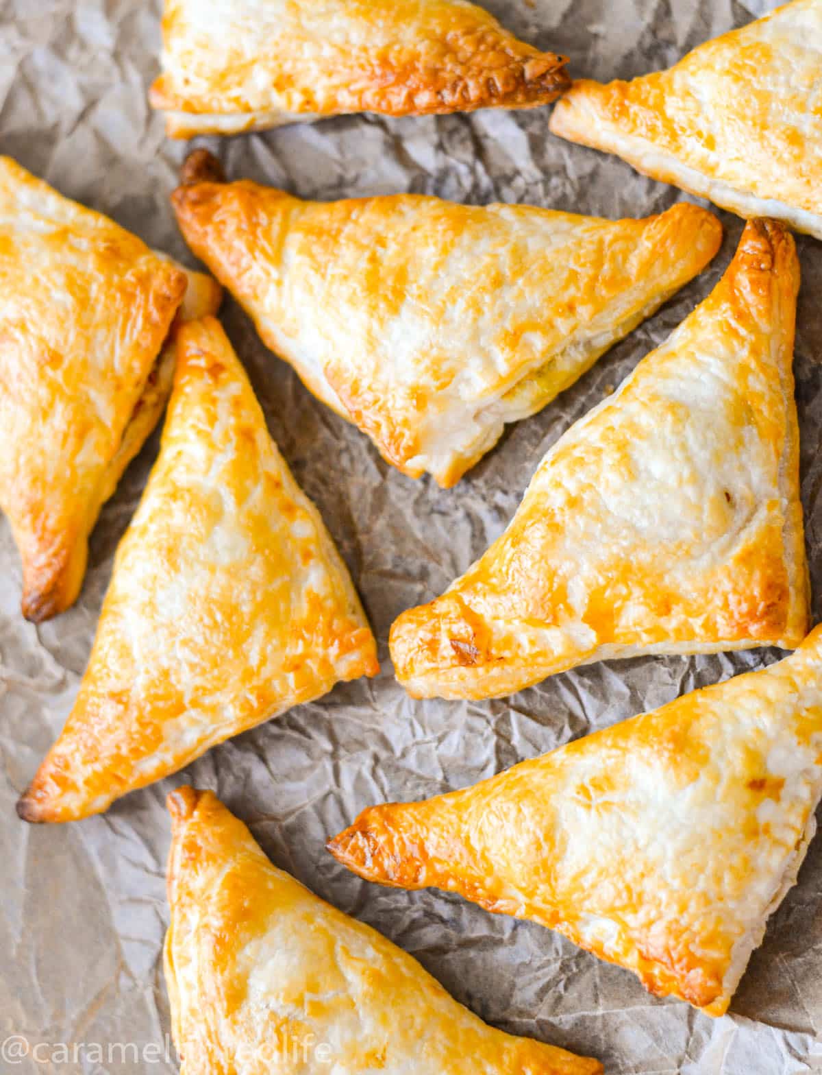 Baked puff pastry samosas on a baking paper