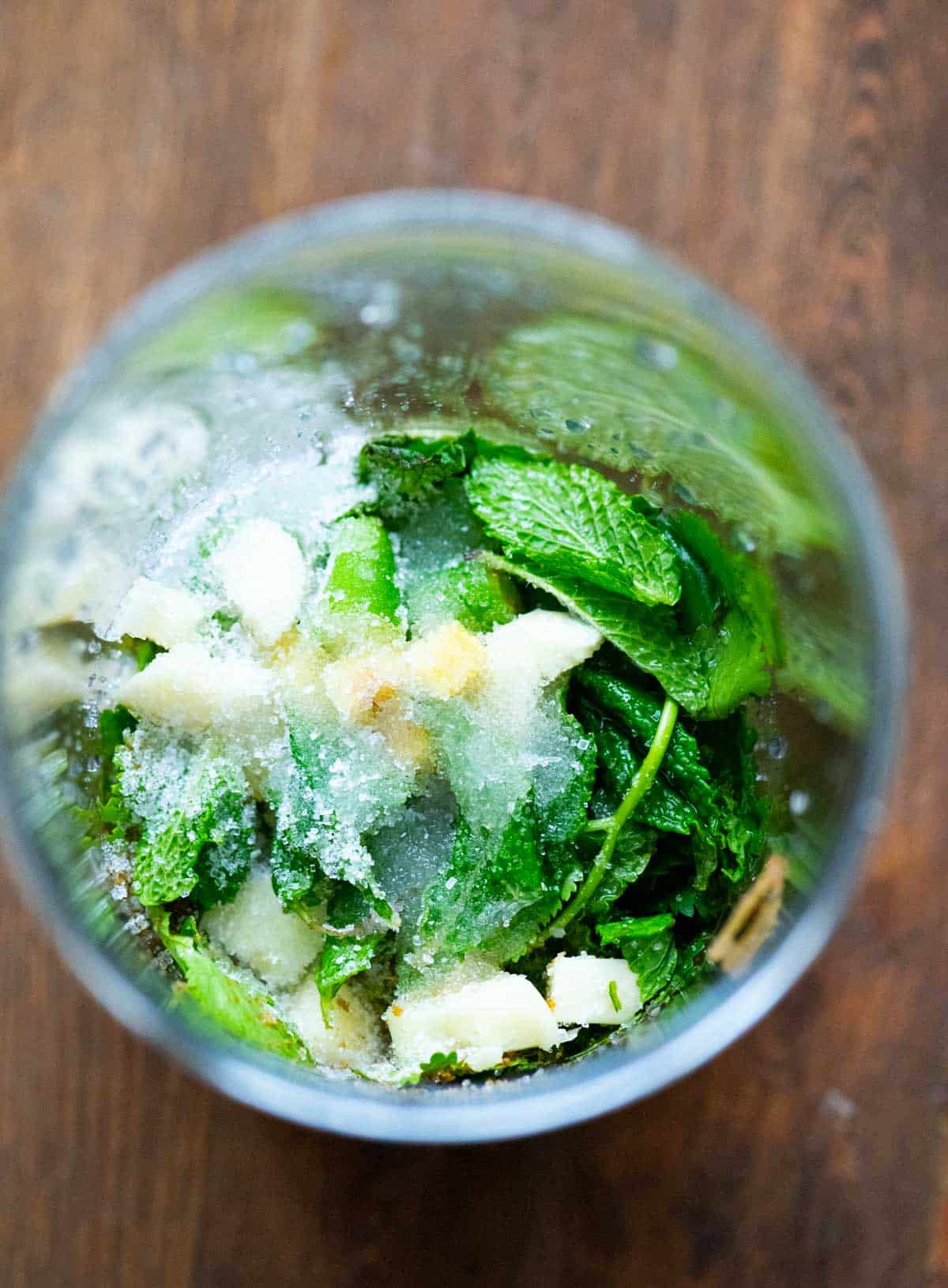 Green chutney ingredients in a blender jar