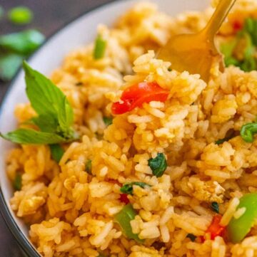 Basil fried rice on a bowl with a fork
