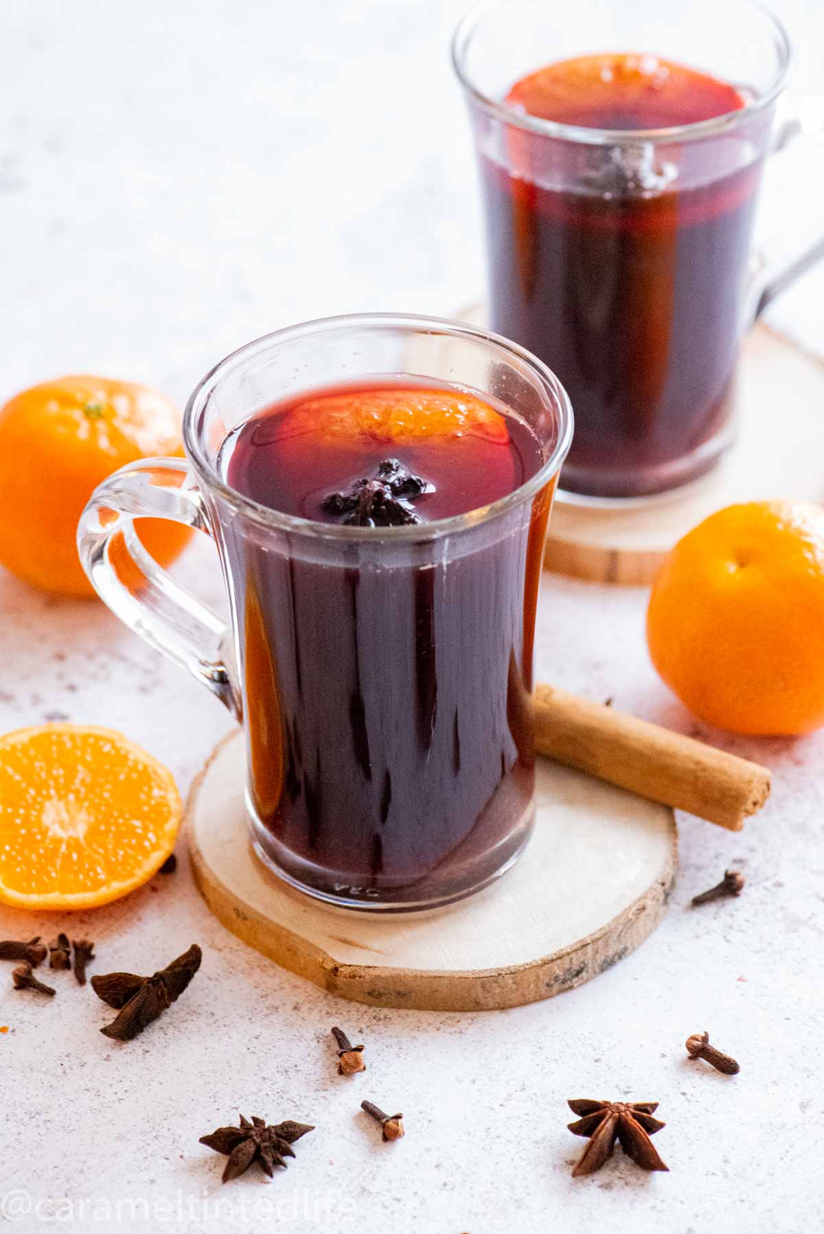 a glass of mulled wine in the foreground, one in the background