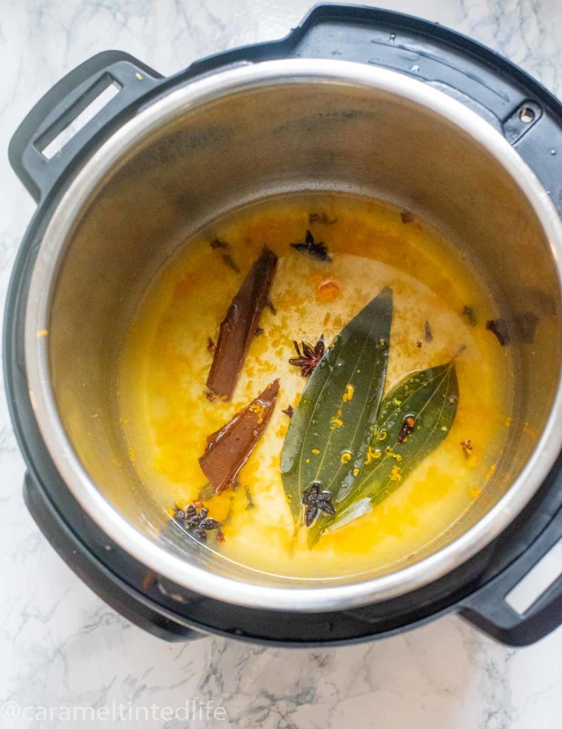 Instant Pot with orange zest, orange juice , bay leaves and spices