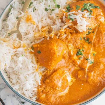 a bowl of rice with chicken tikka masala