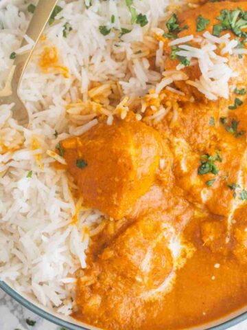 a bowl of rice with chicken tikka masala
