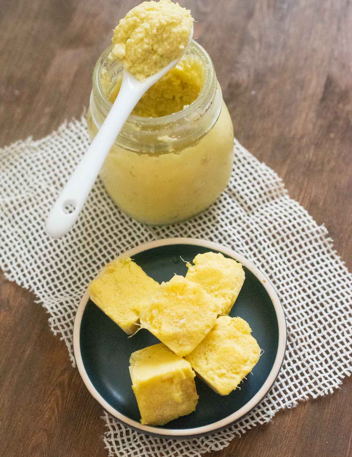 Ginger garlic paste in a glass jar next to frozen blocks of ginger garlic paste