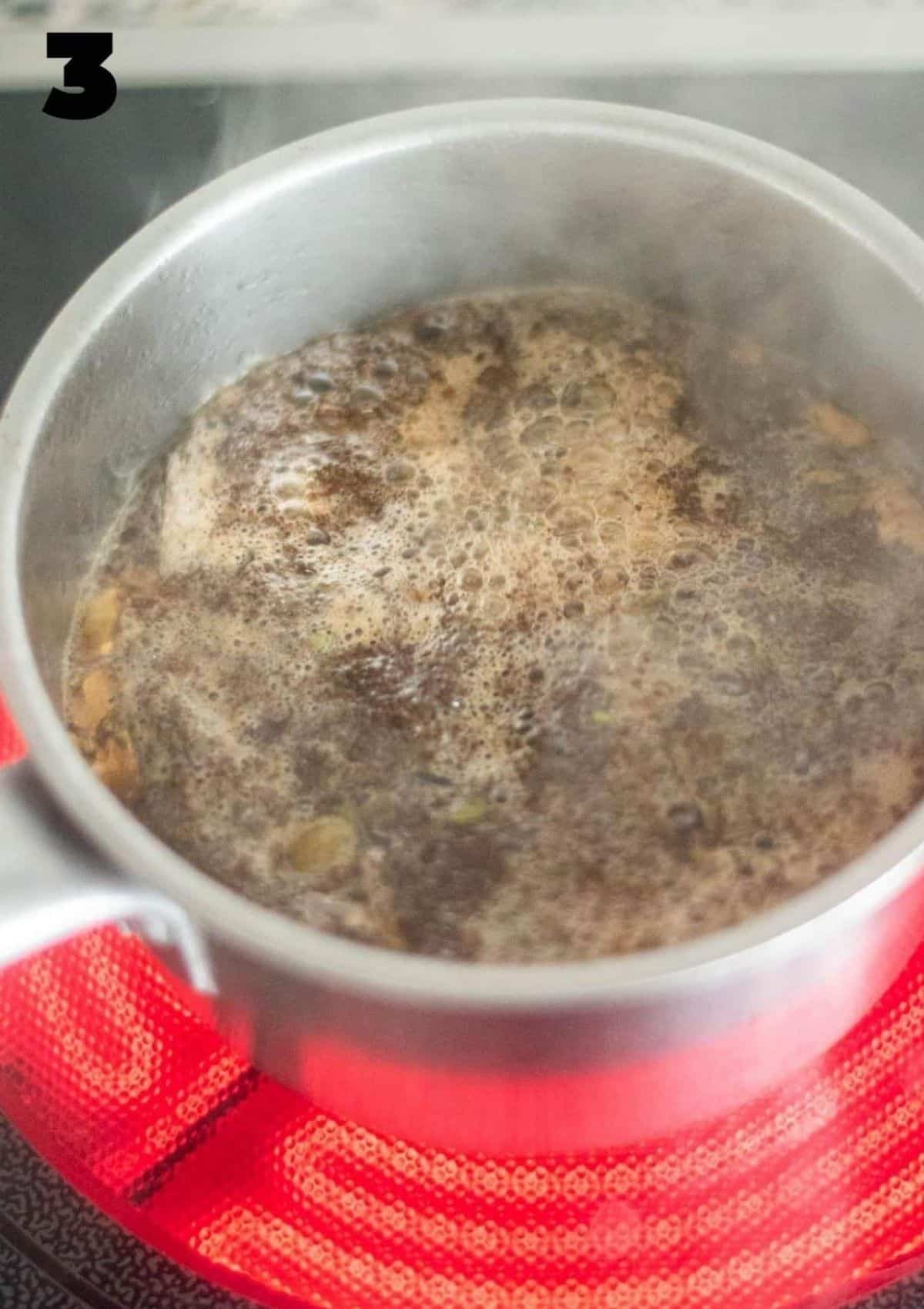 Boiling spices and tea leaves in a saucepan 