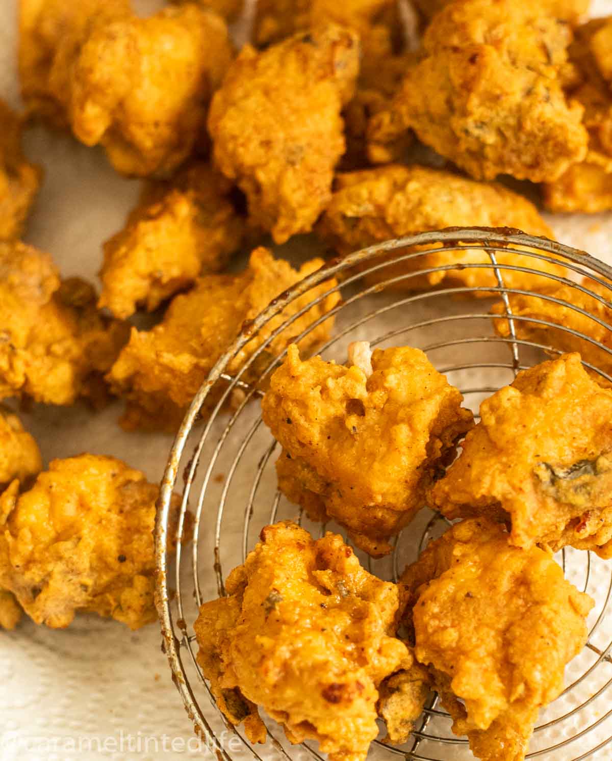 Chicken pakoras from the frying pan, on a kitchen towel