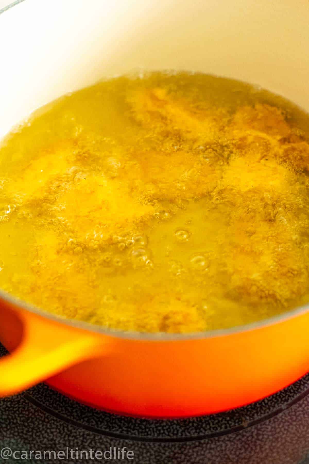 Deep frying chicken pakoras in a dutch oven