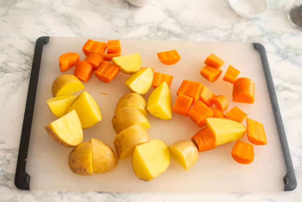 chopped potatoes and carrots on a chopping board