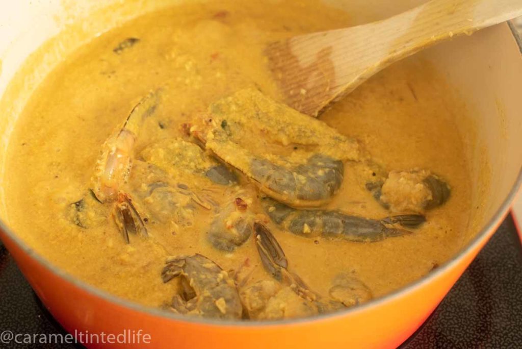 raw shrimp in a pot of curry