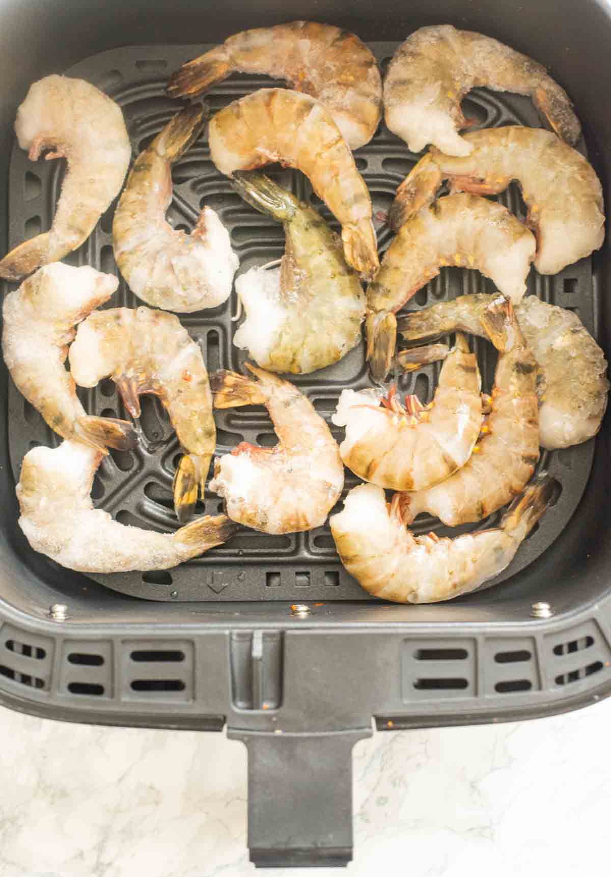 Frozen shrimp in an AIr fryer basket