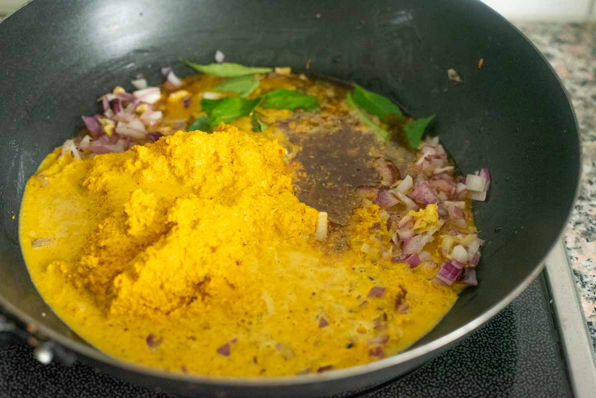 bagara baingan curry ingredients cooking in a wok