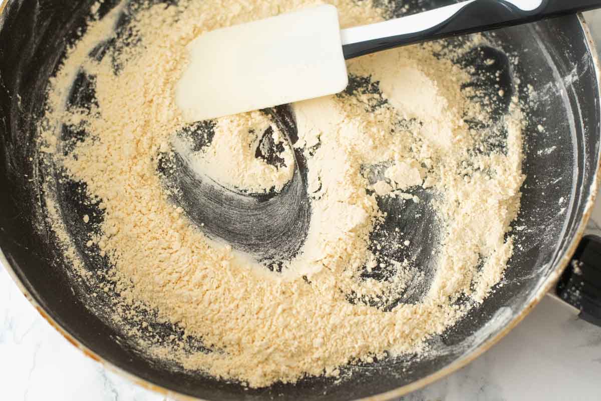 Gram flour roasting in a nonstick pan