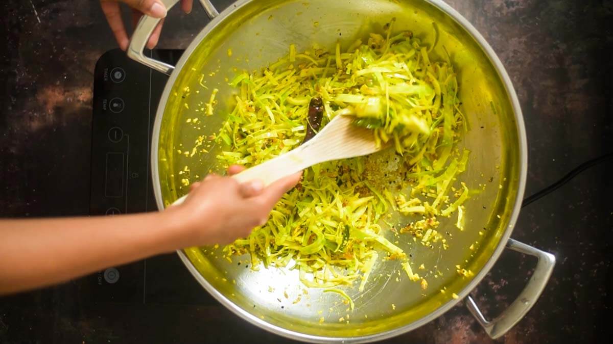 sauteeing cabbage with spices in a wok