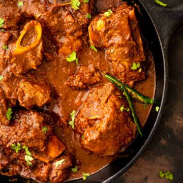 top view of lamb karahi served in a cast iron pan