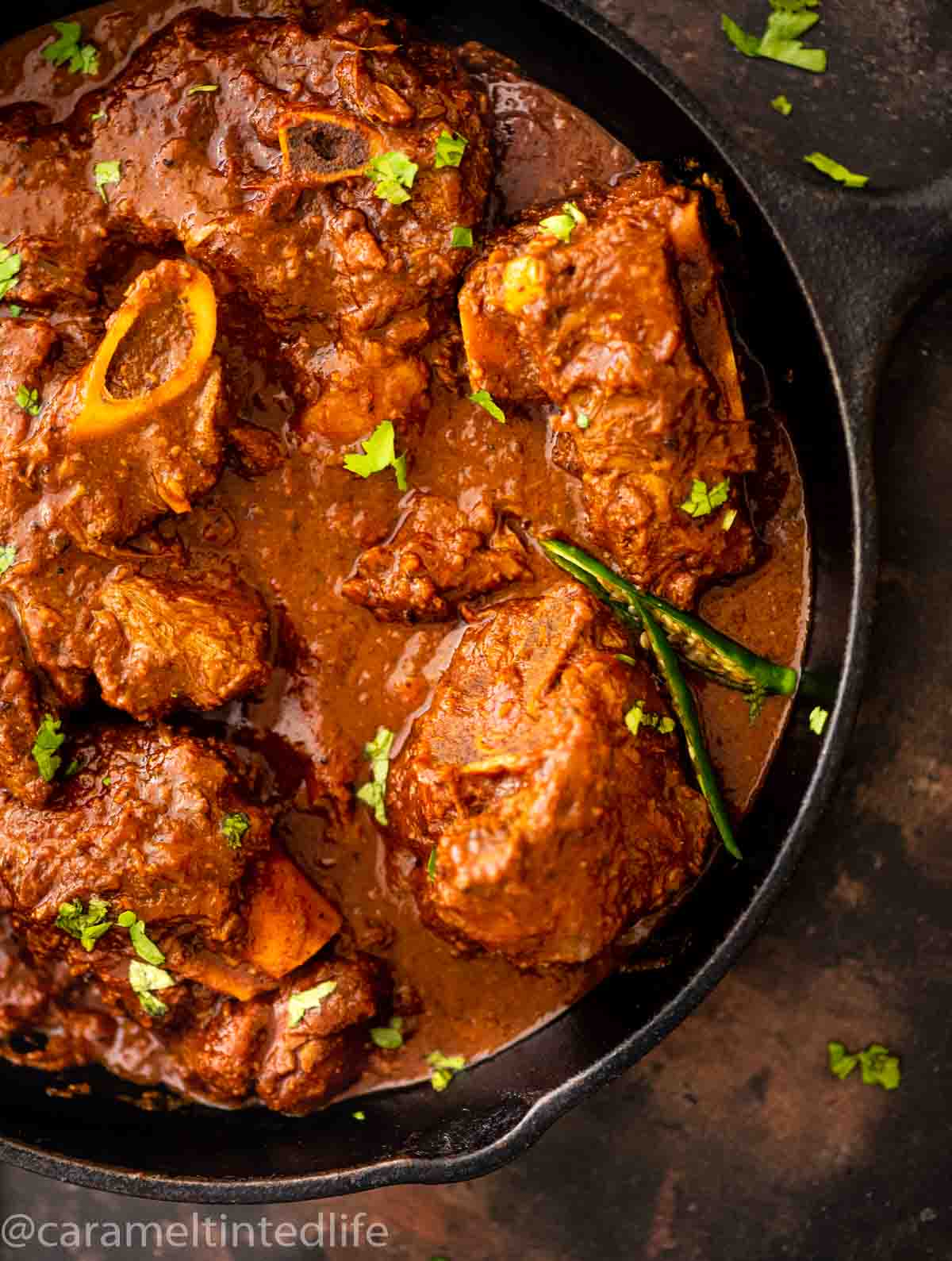 top view of lamb karahi served in a cast iron pan