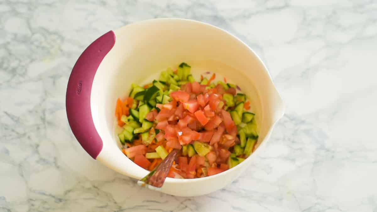 mixing bowl with yogurt and chopped veggies