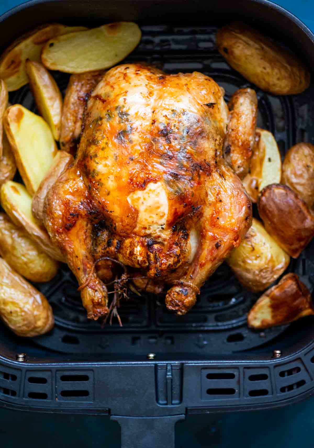 whole roasted chicken with potatoes in air fryer baslket