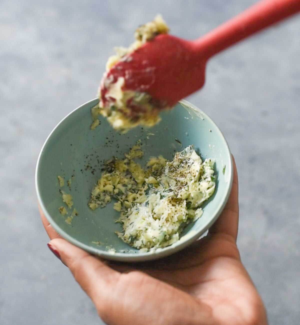 butter with mixed herbs in a small bowl