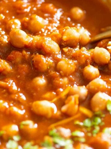 close up of spoon in a bowl of chana curry
