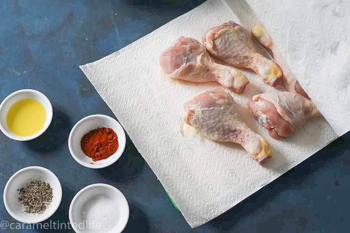 chicken legs on a kitchen paper with spices