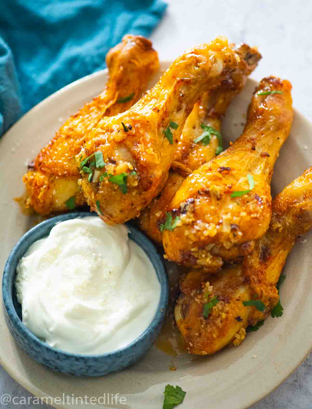 chicken legs in a plate with dip