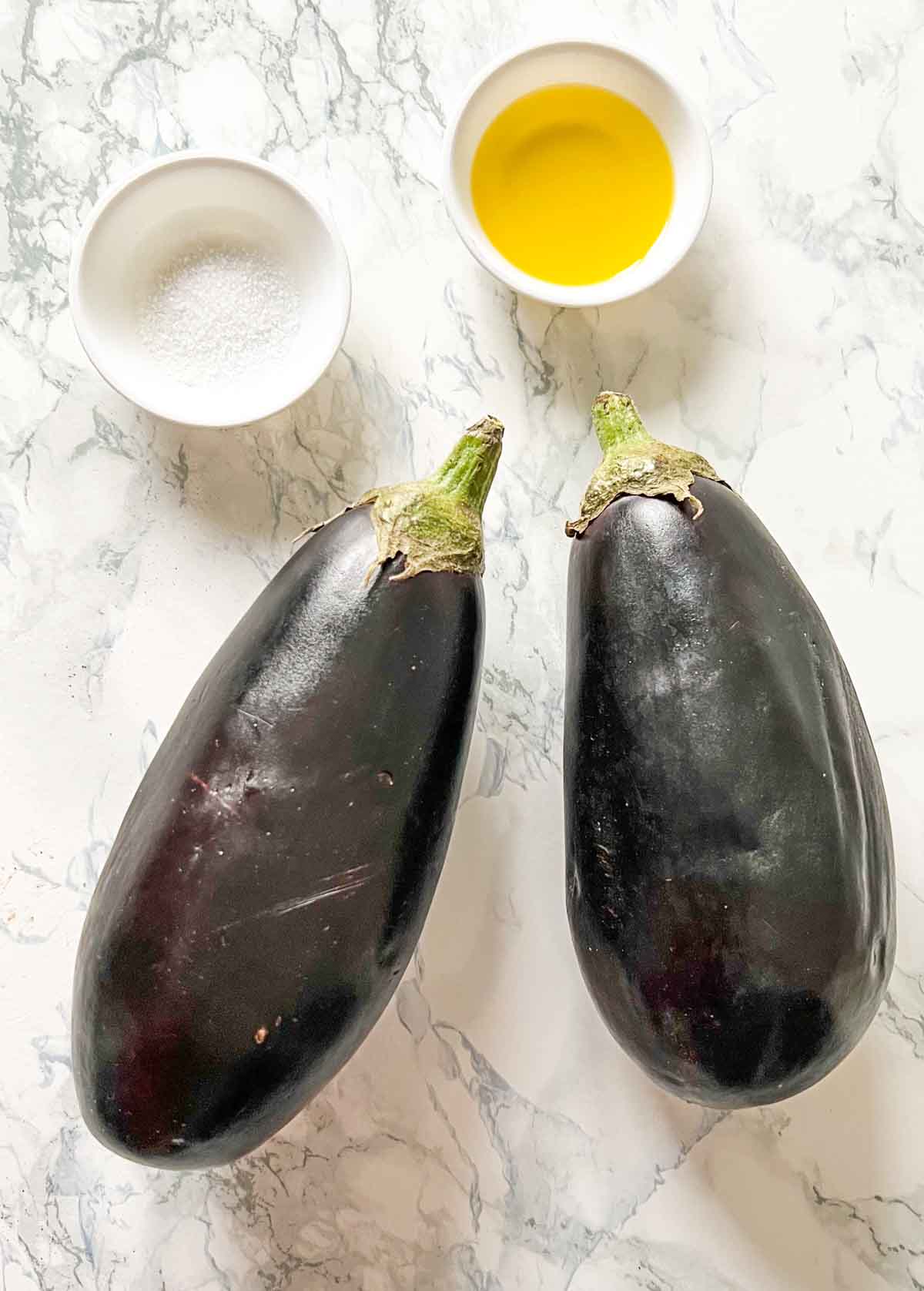 eggplant, salt and oil on a white board
