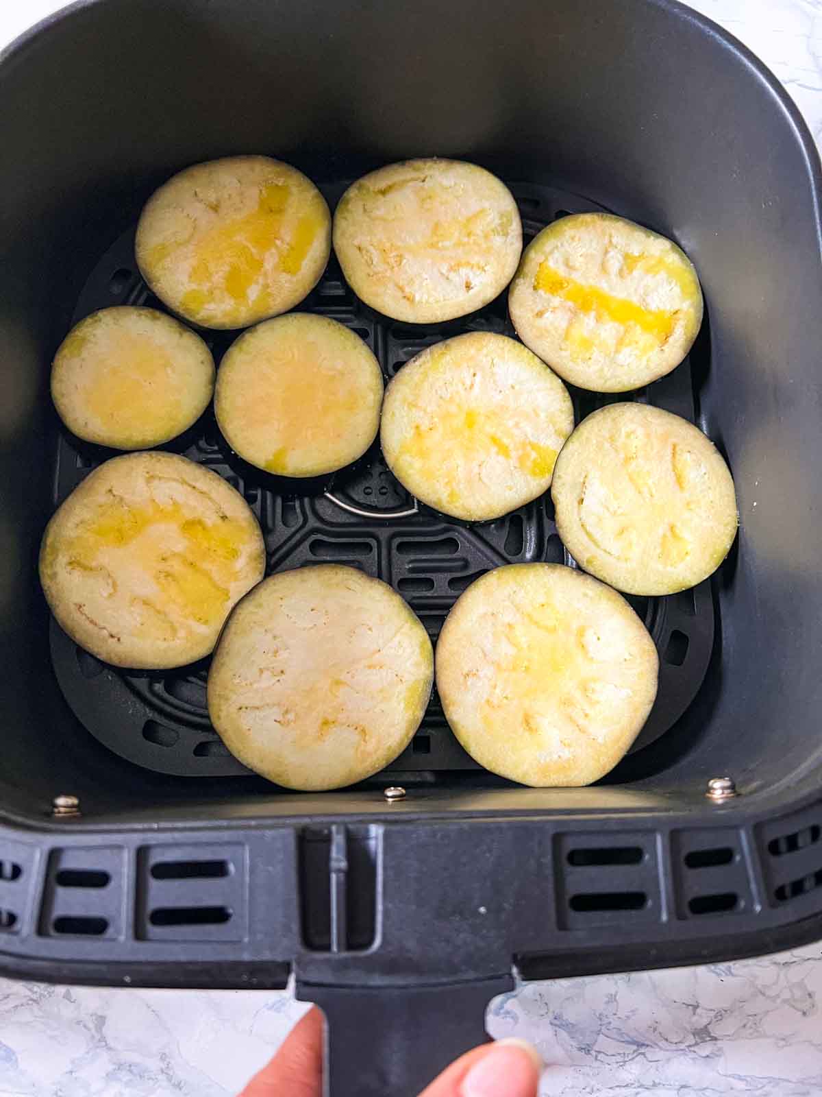 slices of eggplant in an airfryer basket