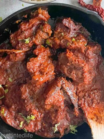 rogan josh curry in a black pan