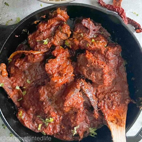 rogan josh curry in a black pan